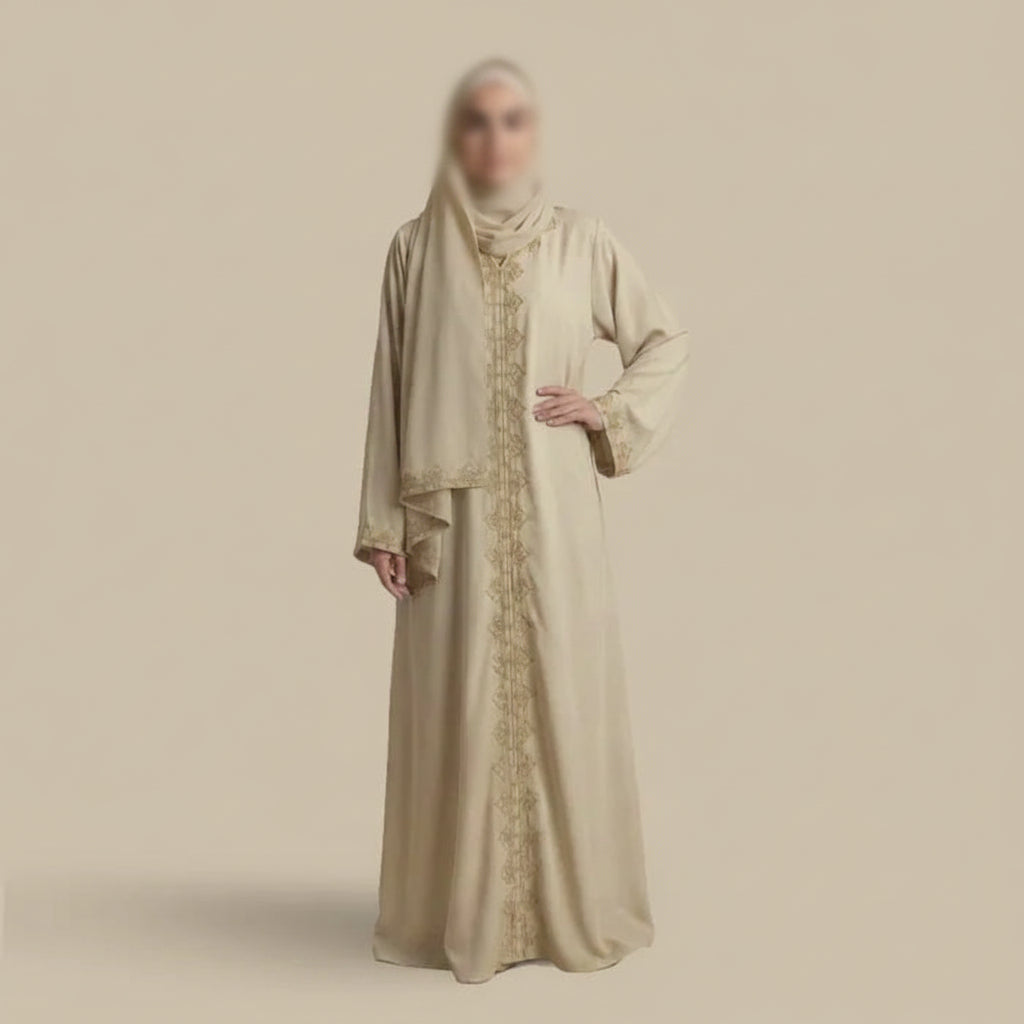 Woman wearing a beige abaya with intricate patterns on a beige background